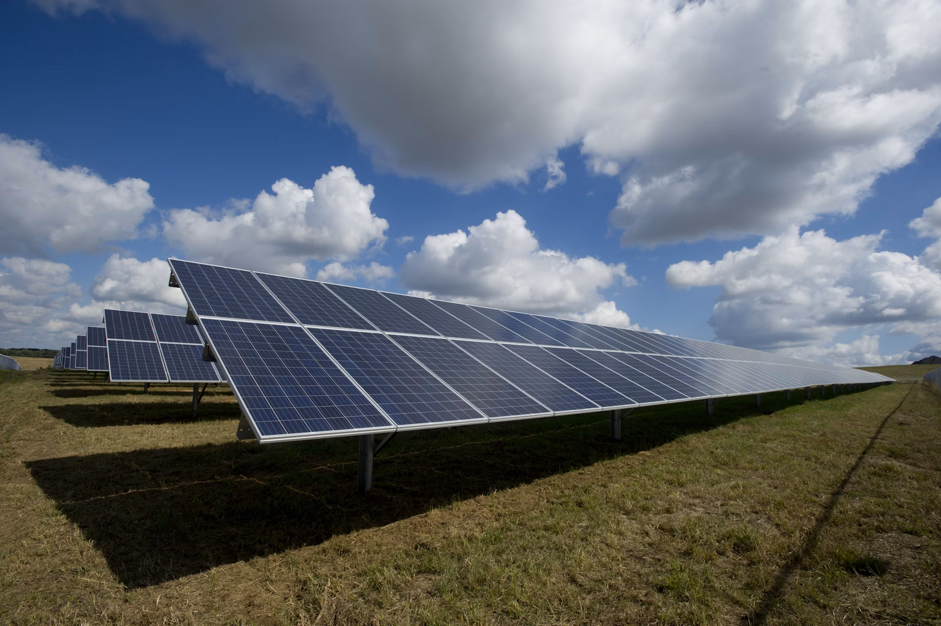 Solar panels field under blue sky